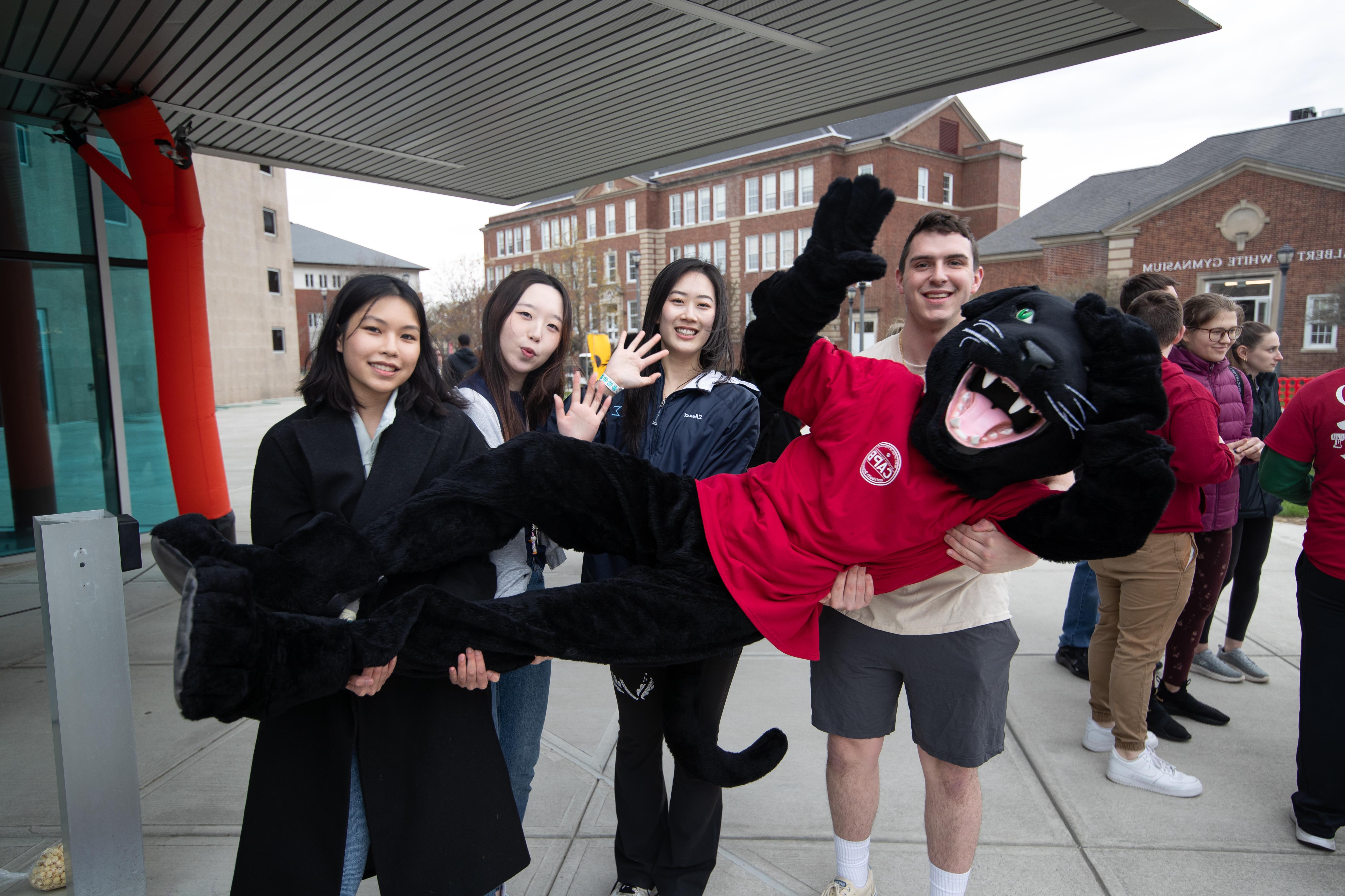 Students hold Paws the mascot at Springfest 2024